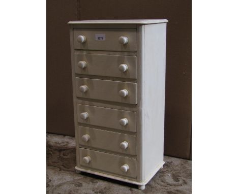 A small table top mahogany chest of six long drawers with button knob handles and painted finish, 30 cm wide x 22 cm deep x 5