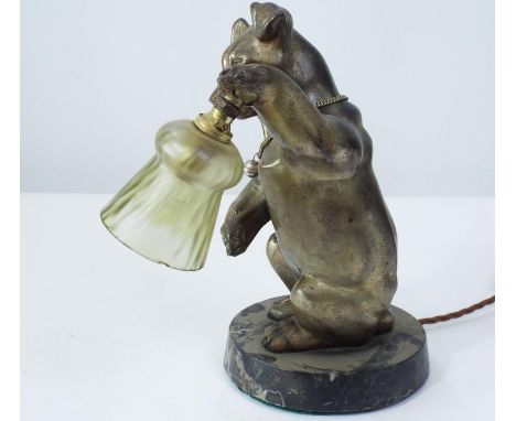 A cast brass model of a terrier, one leg raised supporting an electric light fitting, set on a circular polished marble plint