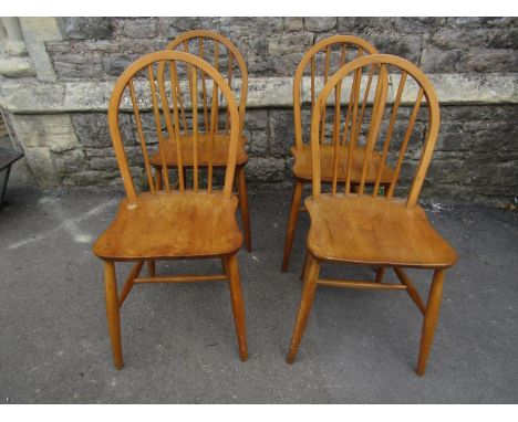 A set of four vintage Ercol light elm and beechwood hoop and stick back kitchen chairs raised on simple turned supports and s