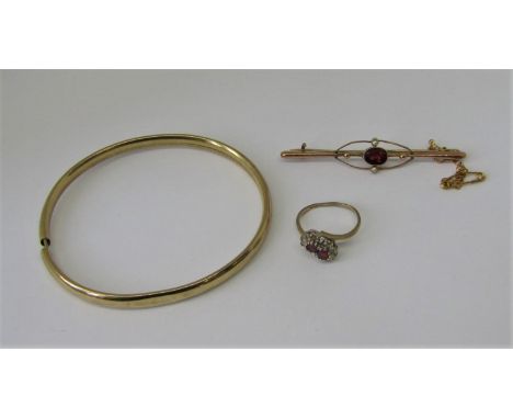 Group of 9ct jewellery comprising an early 20th century brooch set with a garnet and seed pearls, a bangle(af) and a ruby and