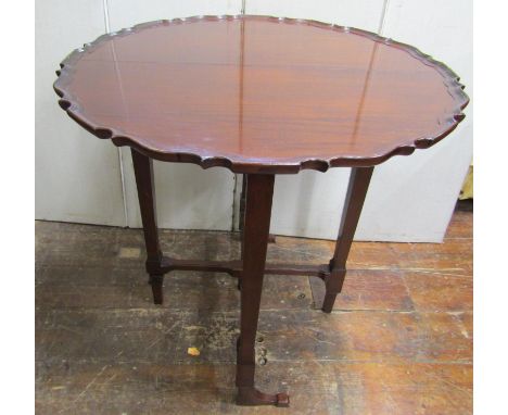 A good quality Edwardian mahogany folding occasional table in the Georgian manner, circular folding top with pie crust border