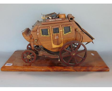 Scale hardwood model of a US mail carriage inscribed Wells - Fargo, on a plinth stand, 51 cm long 