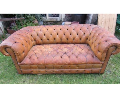 A Chesterfield sofa in mid-tan leather upholstery with overall buttoned finish, 185cm wide 