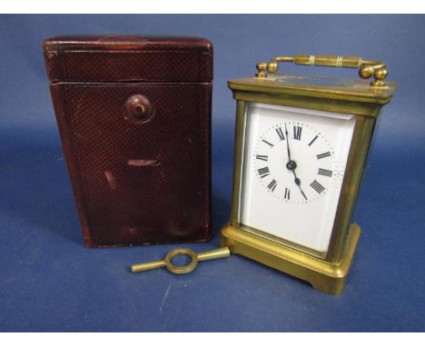 A brass  cased carriage clock, the back engraved with a standing lion, 11cm high in a Morocco leather carry case, key 