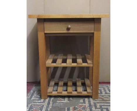 A good quality contemporary light oak kitchen  work stand, the rectangular overhanging top raised on square cut supports unit