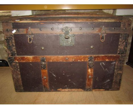 A domed and timber lathe trunk with hinged lid and iron fittings 
