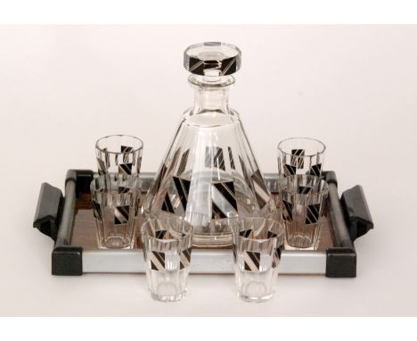 A 1930s Bohemian Art Deco decanter set comprising a facet cut conical decanter and a set of six slice cut tumbler glasses all