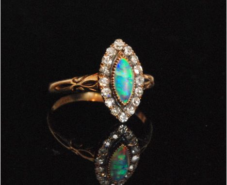 An early 20th Century 18ct opal and diamond cluster ring, central collar set marquise opal within sixteen stone claw set diam