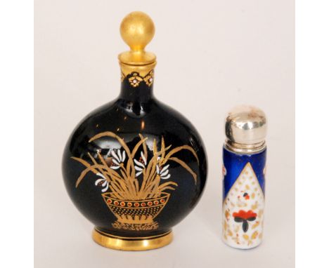 A 19th Century Coalport scent bottle of moon flask form decorated with an enamel and gilt basket of flowers and grasses again