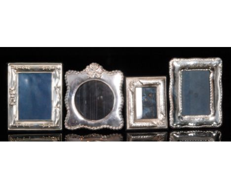 A modern hallmarked Britannia silver shaped rectangular embossed photograph frame and a miniature hallmarked silver fluted ex