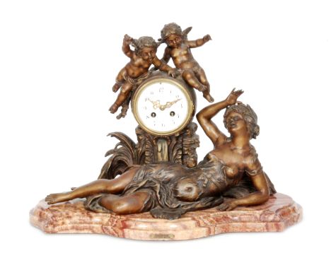 A late 19th Century French spelter mantle clock white enamelled dial and the eight day striking movement surmounted with two 