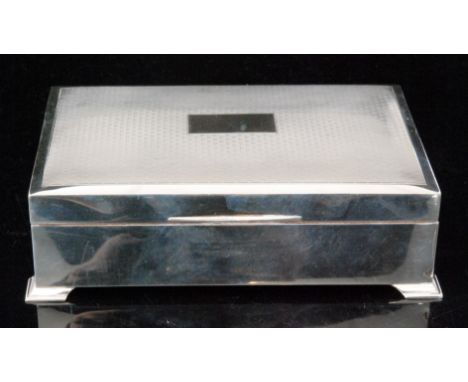 A 1960s hallmarked silver rectangular cigarette box, the lid with engine turned design opening to reveal cedar lined interior