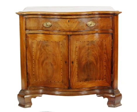 A mahogany serpentine-fronted cabinet in the Georgian style, the top with cross-banded border over a single frieze drawer and