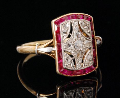An 18ct Art Deco style ruby and diamond ring, a rectangular head with central pierced pave set diamond panel within a ruby se