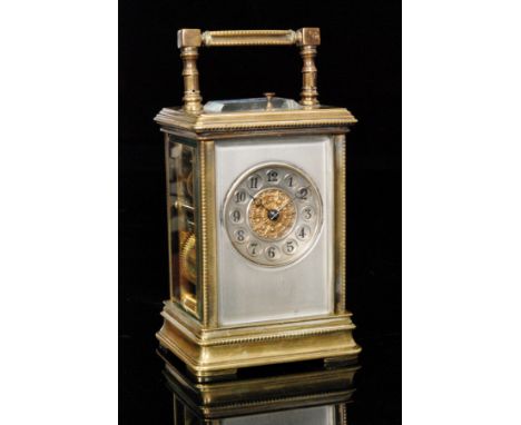 An early 20th Century brass carriage clock circular Arabic dial within a silvered border, push button repeat in beaded edge c