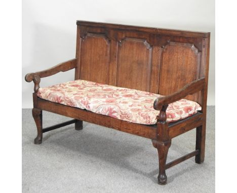 A George III oak settle, with cushion, 140cm