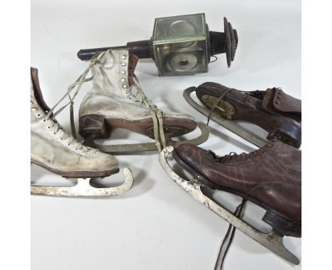 A box of vintage ice skates, together with a brass coaching lamp