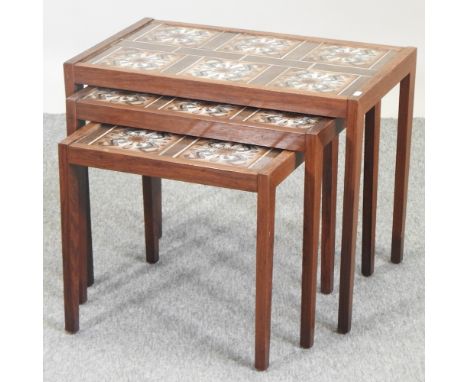 A nest of three 1970's teak occasional tables, with tile tops, largest 64cm