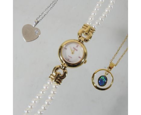 An unmarked necklace, suspended with an opal pendant, together with a necklace with a gem set heart pendant and a ladies dres