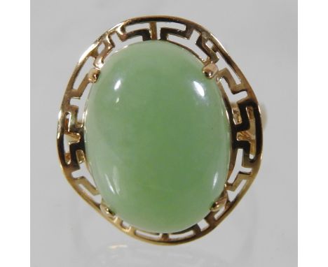 A 9 carat gold and jade coloured cabochon set ring