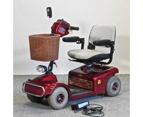 A red Shoprider mobility scooter, with charger