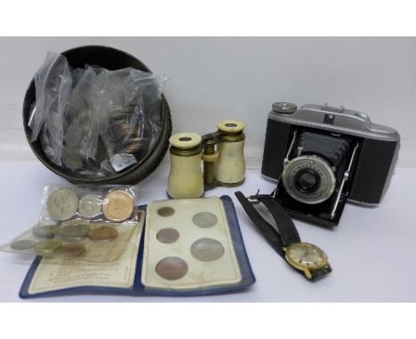 A collection of coins, a pair of ivory binoculars, a Timex wristwatch and a camera