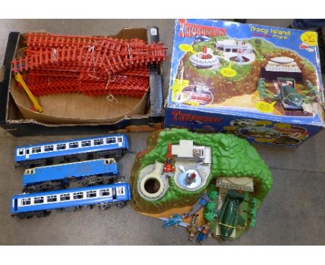 A Thunderbirds Tracy Island and a plastic battery operated model railway with track