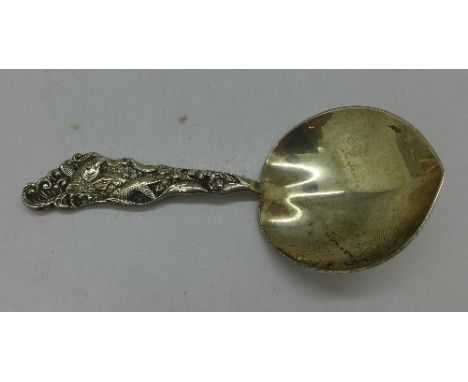 A silver caddy spoon, the handle decorated with a carp