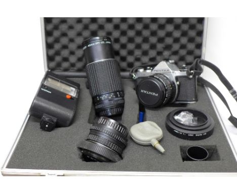A Pentax ME camera and three lenses and flash gun, cased