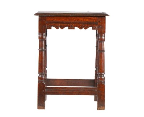 An Elizabeth I/James I oak joint stool, circa 1600-20

Having a triple-reeded top, bicuspid-shaped rails with S-scroll carvin