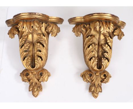 A pair of giltwood wall brackets, in the early 18th century Kentish manner,Each with a shaped bowed shelf on acanthus-leaf su