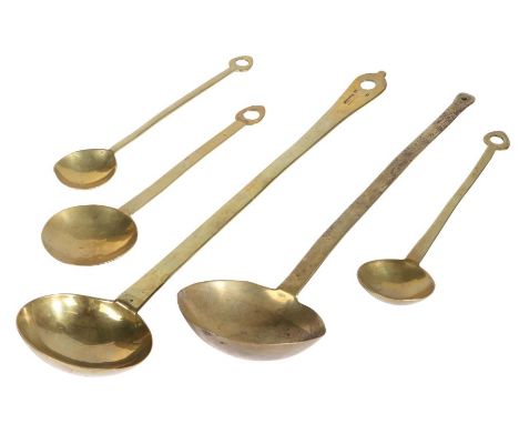An 18th century brass maker stamped ladle, EnglishCast with a deep circular bowl, flat tapering handle with 'dog-nose' termin