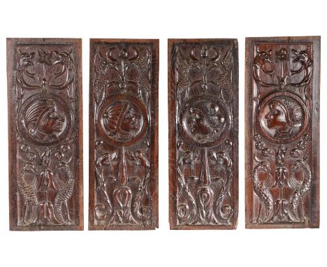 A set of four carved oak Romayne-type panels, French, circa 1520-40Each with a portrait roundel, topped by paired fanciful bi