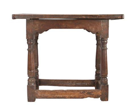 An Elizabeth I oak centre table, circa 1600Having a one-piece top board with end-cleats, all rails with integral scroll-profi