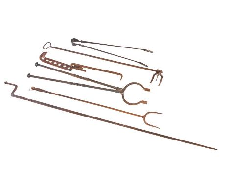 A group of iron fireside implementsTo include a log fork, tongs and adjustable hook (6)Provenance: Doughton Manor, Doughton, 