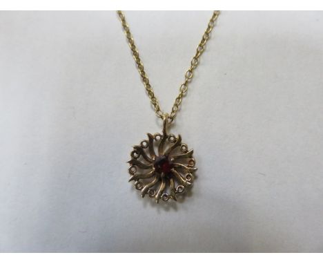 9ct GOLD PENDANT SET WITH RUBY COLOURED STONE ON 9ct GOLD CHAIN 
