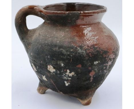 A Song Dynasty? brown glazed ewer or jar raised on three feet, single handle incorporated to the rim, D: 17 cm, H: 16 cm. P&P