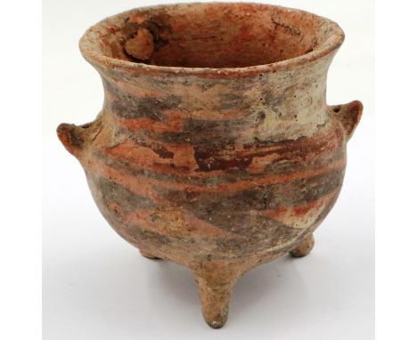 A Neolithic period terracotta cauldron of diminutive proportions, raised on three supports and retaining some of its polychro