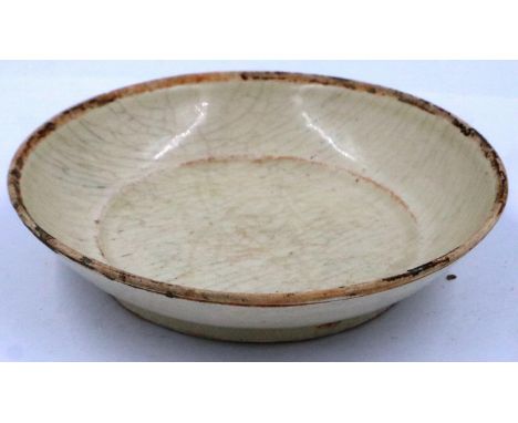 A Ming Dynasty light-celadon glazed saucer or shallow dish, glaze stops just short of the rim, D: 14 cm, H: 3 cm. P&P Group 2