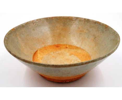 A Ming Dynasty glazed bowl, raised on a wide foot and of tapering form, having painted character marks to the lower body, D: 