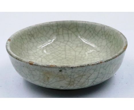 A Song Dynasty crackle glazed bowl, shallow and footed, D: 11 cm, H: 4 cm. P&P Group 2 (£18+VAT for the first lot and £3+VAT 
