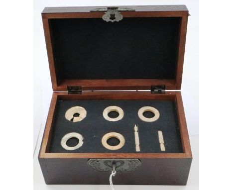 A group of seven archaic calcified jade burial goods, likely Han Dynasty, set within a contemporary fitted box, figure pendan