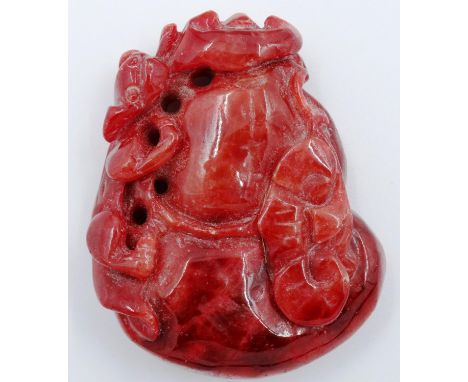 A carved red jade panel, decorated with a prowling leopard, 5 x 4 cm. P&P Group 2 (£18+VAT for the first lot and £3+VAT for s