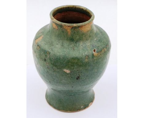 A Ming Dynasty green glazed vessel, D: 12 cm, H: 17 cm. Firing faults including loss of glaze and pitting, no visible later d
