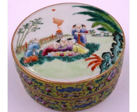 Qing Dynasty famille rose circular porcelain covered box, the lid finely painted with children playing in a garden setting, t