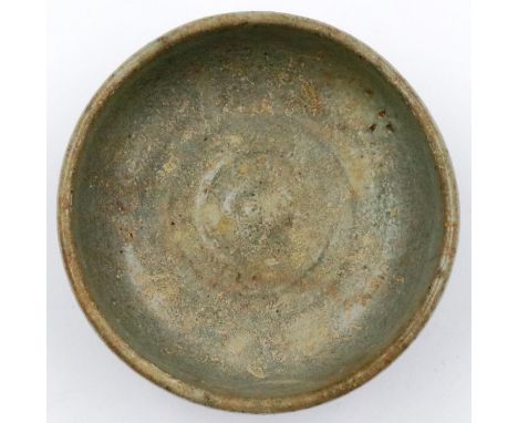 A Ming Dynasty celadon glazed footed bowl of diminutive proportions, D: 8 cm, H: 3 cm. P&P Group 1 (£14+VAT for the first lot
