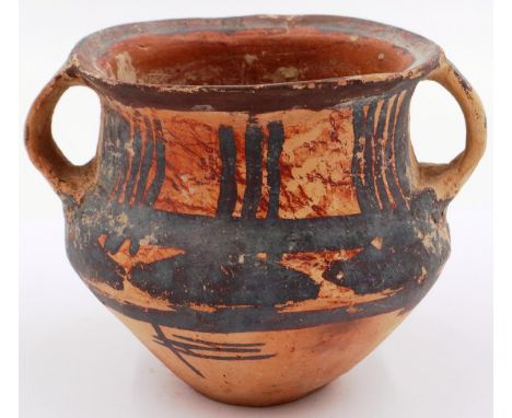 A Neolithic period painted terracotta twin handled pot, decorated with geometric designs, H: 8 cm, D: 10 cm. P&P Group 2 (£18