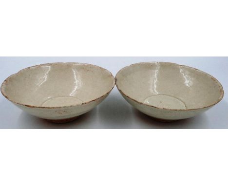 A pair of Ming Dynasty glazed bowls, each footed with shaped rims, D: 15 cm, H: 5 cm. Small losses to both rims. P&P Group 2 