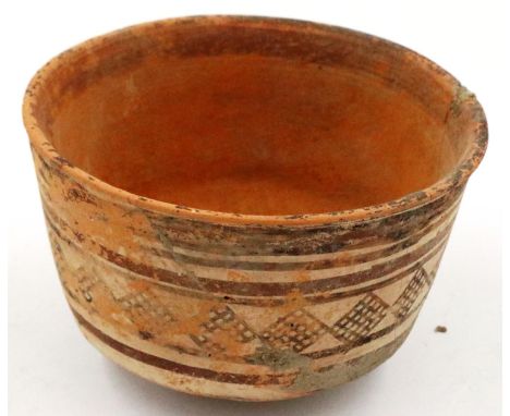 An Indus Valley Neolithic period bowl, footed, D: 10 cm, H: 7 cm. Repaired damage to the body. Most of the design remains. P&
