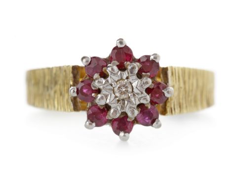 EIGHTEEN CARAT GOLD RUBY AND DIAMOND CLUSTER RING1970s, with a central illusion set diamond surrounded by round rubies, on a 